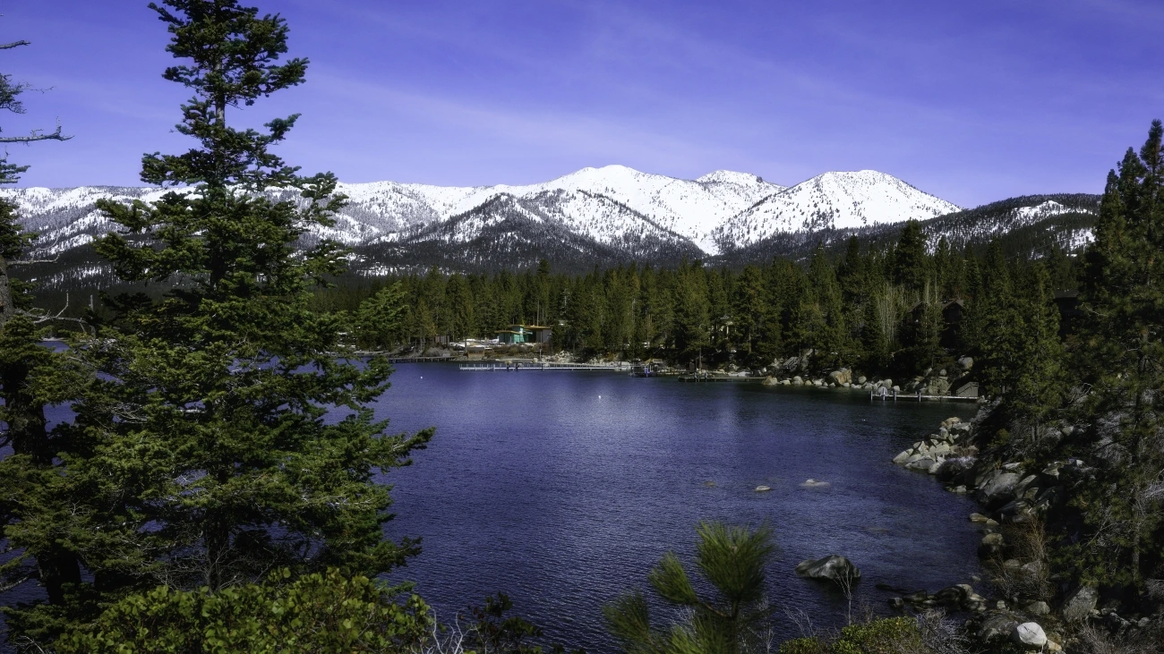 Lake Tahoe, surrounded by evergreens and snowy mountains