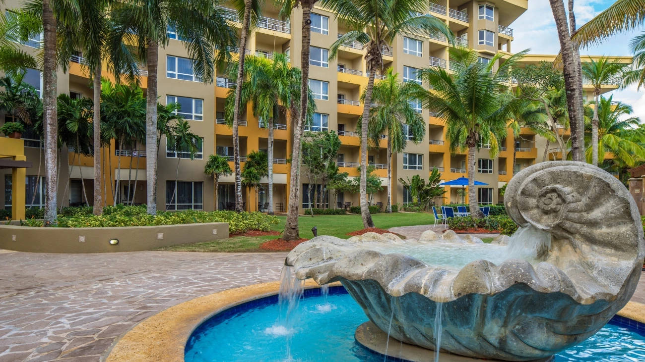 A fountain spraying water in front of a resort