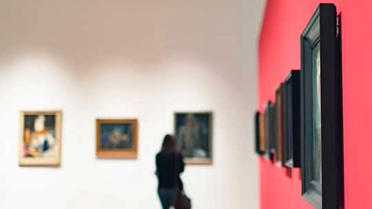 A person contemplating art in a gallery