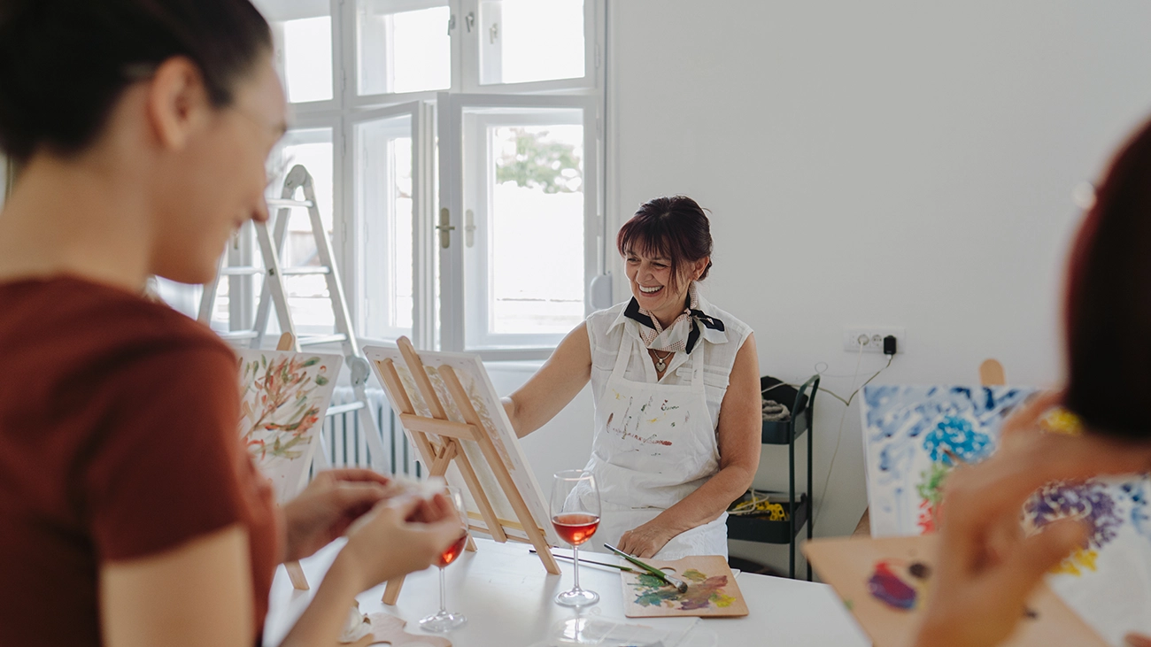 Women enjoying a group painting class