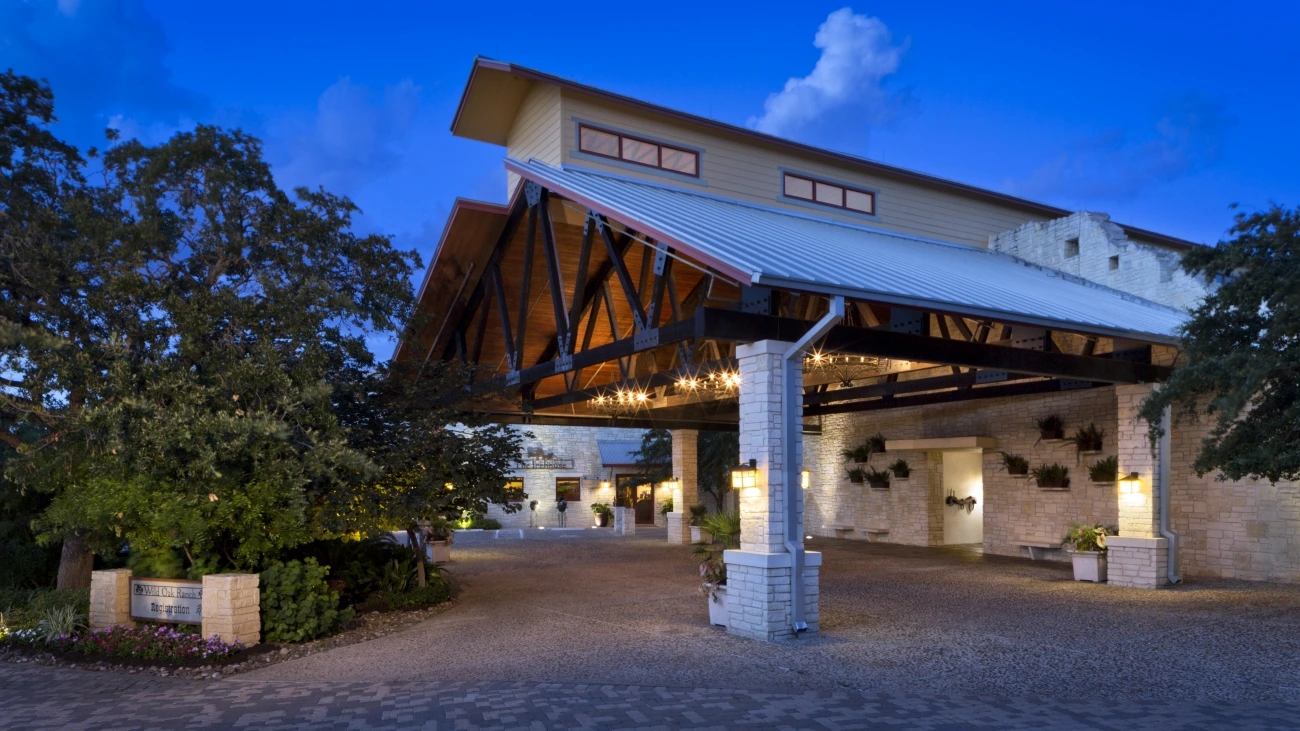 Resort entrance with landscaping and lights at night